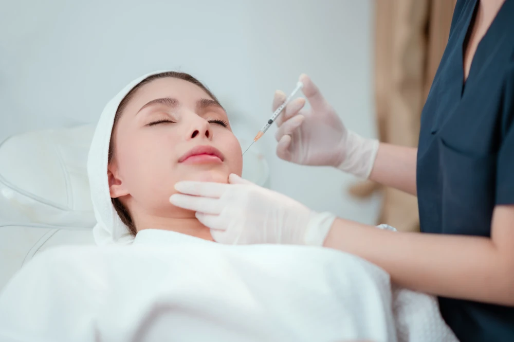 A woman receiving a safe fat transfer injection in a medical spa.