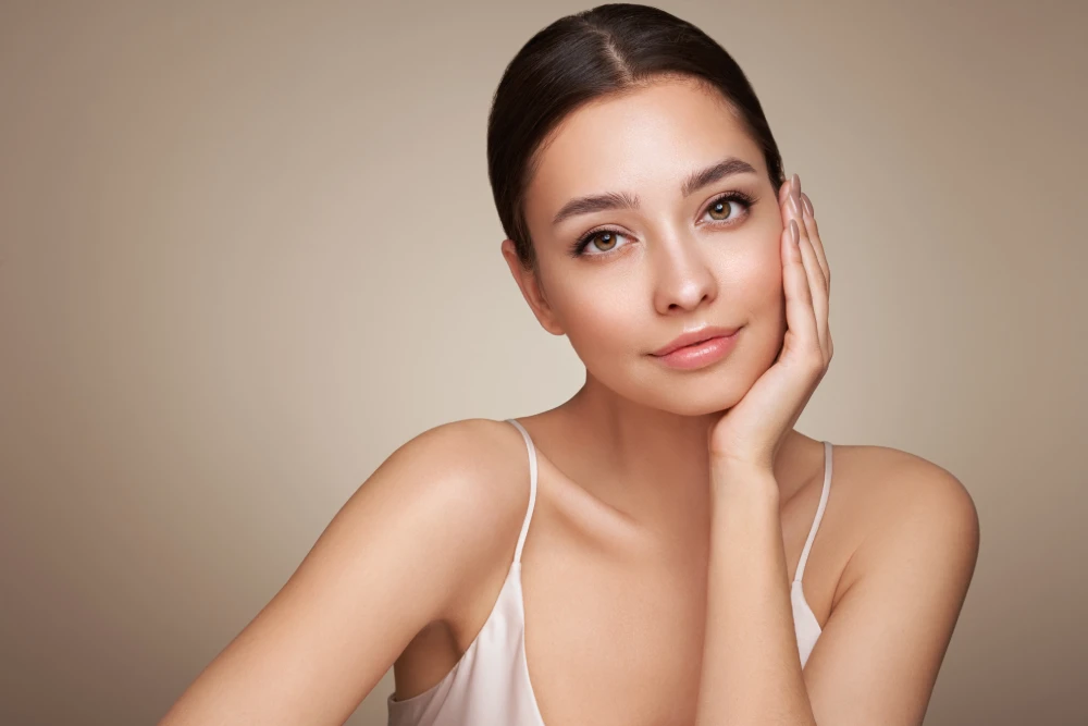 Woman with glowing skin after microneedling treatment.