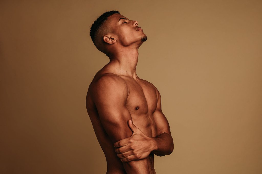 Fit man showcasing toned results after CoolSculpting.